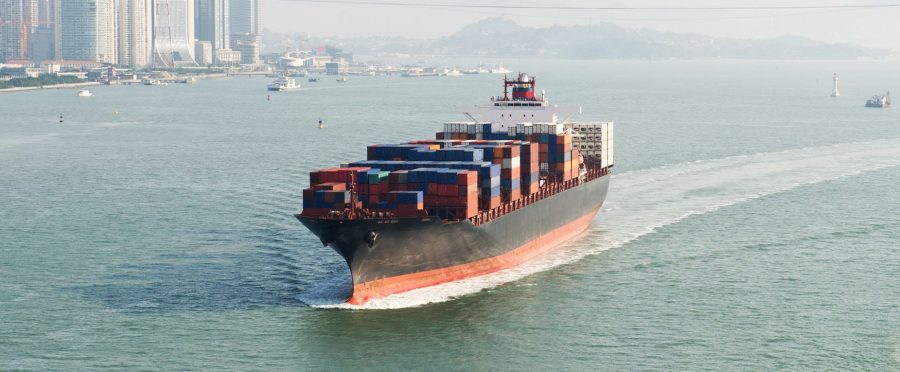 large-container-ship large container ship traveling on waterway near city